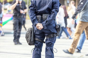 Female police officer on duty, blurred people in the background