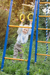 Obraz premium little boy on playground on summer day