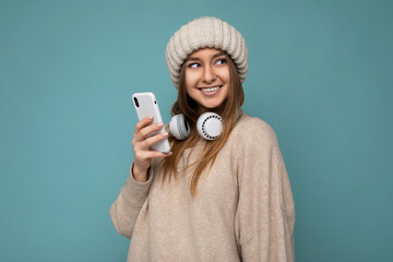 Photo shot of beautiful joyful smiling young female person wearing stylish casual outfit isolated...