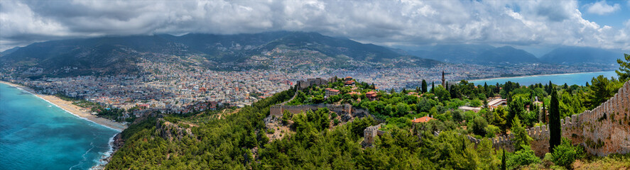 Fototapeta na wymiar Fragments of the fortifications of a medieval fortress on a hill above the Turkish city of Alanya
