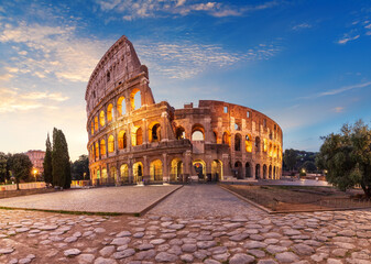 Fototapeta na wymiar Coliseum at sunrise, summer view without people, Rome, Italy
