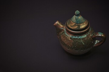 Ceramic vintage teapot for tea ceremony in chinese style isolated on black background.