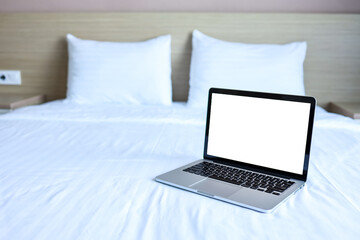 Mock up Blank screen laptop on the bed for advertising and text.