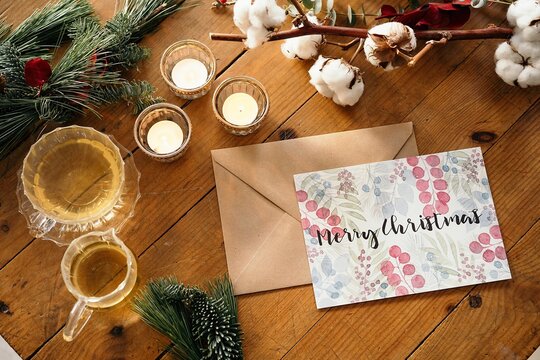 Festive Christmas composition with colorful postcard against wooden background