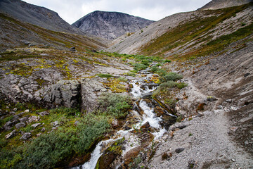 Fototapeta premium landscape of the Khibiny mountains with rocks and a mountain stream on a cloudy day. Kola Peninsula, Russia