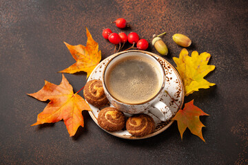 Black coffee and cookies on a table. Autumn background
