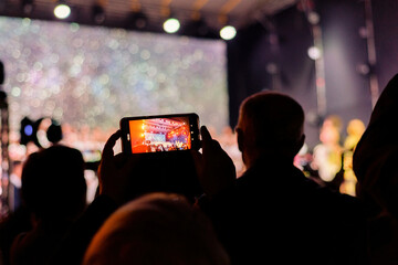 Mobile camera filming the performance of the concert.