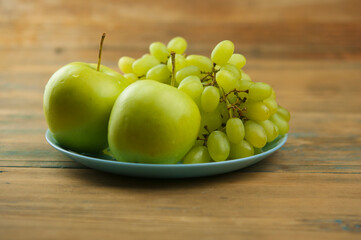Grapes with apple on the table