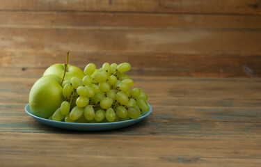 Grapes with apple on the table