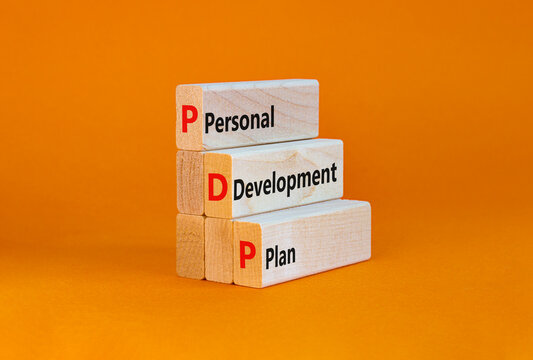 PDP, Personal development plan symbol. Words PDP, Personal development plan symbol on blocks on a beautiful orange background. Business, PDP, Personal development plan symbol concept. Copy space.