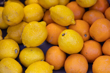 Fresh oranges and lemons on a market stall