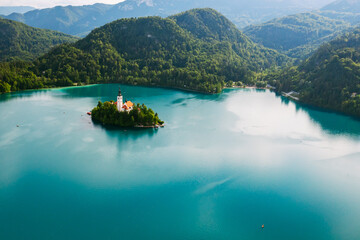 Lake Bled with turquoise blue water with small island on the background of Julian Alps.