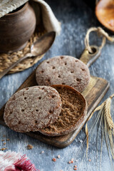 Gray rye tortillas on a wooden cutting board