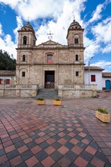 Nemocon, Cundinamarca, Colombia. July 2, 2021: Facade of San Francisco de Asís church and blue sky.