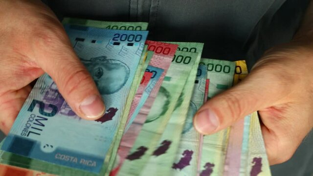 Costa Rica currency various banknotes converted in hands 