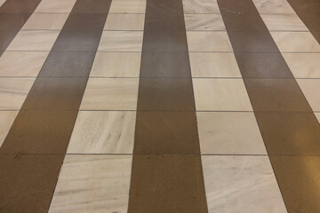 Close up view of dark and light brown tiles on floor. Construction Materials concept. Greece. 