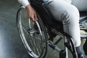 Obraz premium cropped view of young handicapped businessman sitting in wheelchair