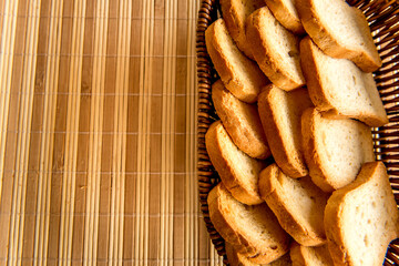 Basket with toasted bread on breakfast table.