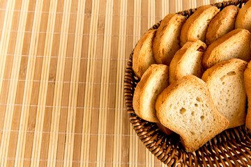 Basket with toasted bread on breakfast table.
