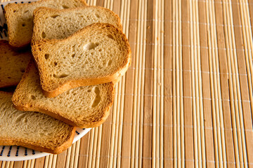 Basket with toasted bread on breakfast table.
