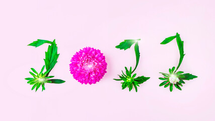 Obraz premium Floral petals and leaves in form of numbers 2022. Inscription on pink background. New year concept