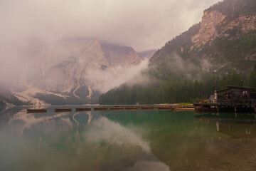 Beautiful landscape of Braies Lake Lago di Braies, romantic place with wooden bridge and boats on the alpine lake, Alps Mountains, Dolomites, Italy, Europe