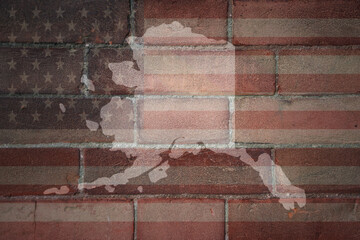 map of alaska state on a painted flag of united states of america on a brick wall