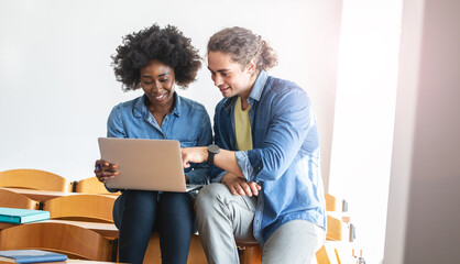 Two classmate students sitting in classroom and preparing for lecture.Educational and friendship...