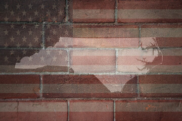 map of north carolina state on a painted flag of united states of america on a brick wall