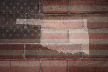 map of oklahoma state on a painted flag of united states of america on a brick wall
