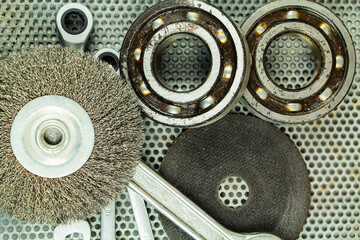 Metalworking tools, steel parts, a wrench, on the background of a metal lattice.