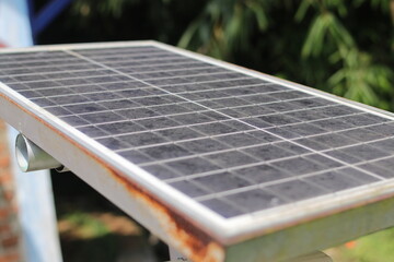 Fototapeta premium Defocused abstract background of dirty solar panel in the backyard. Alternative energy concept