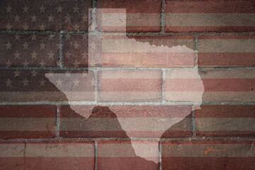 map of texas state on a painted flag of united states of america on a brick wall