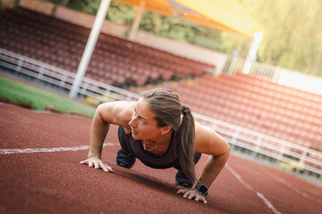 Young athletic woman stretches and prepares to run. strong sport woman