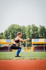 Young athletic woman stretches and prepares to run. strong sport woman