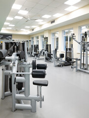 an empty gym with exercise equipment. 