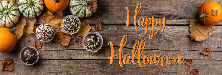 Funny Halloween cakes for party. Halloween background with pumpkin and cake. Autumn, Halloween, party concept. Long format with copy space