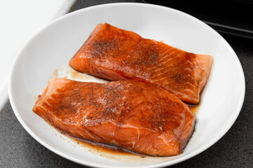 Marinated trout. Preparing fish for grilling. Trout in grill sauce. Healthy Homemade food. Photo
