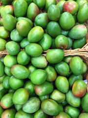 A lot of green mango on sale at farms market. Food background. Mobile photo