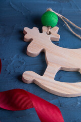 Banner Top view with Christmas toys and decorations on a dark background. Wooden toy deer for the Christmas tree. The concept of a New Year's holiday. Space for text. flat lay