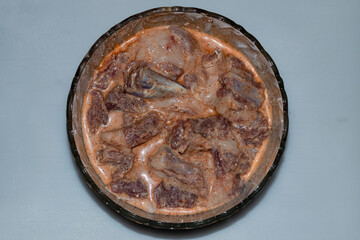 Raw meat products, Marinated Lamb Meat or mutton in bowl isolated on white background top view