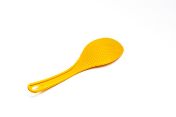 Yellow plastic rice spoon isolated on white background