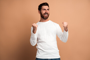 Extremely excited overjoyed man with beard making yes gesture, amazed with his victory, triumph....