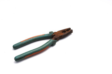 Old used rusty pliers with green grip isolated on white background.