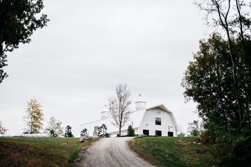Country road leading to a white barn or church