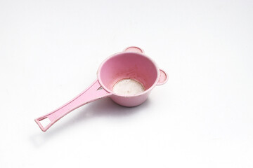 Old used pink plastic tea strainer (colander) isolated on white background