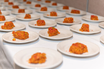Small saucers of Halwa cake desserts served to guests at traditional Indian party ceremony.