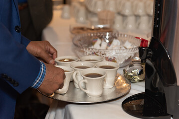 Brewed coffee stacked on a tray to bring back to the family to drink at the banquet dinner party