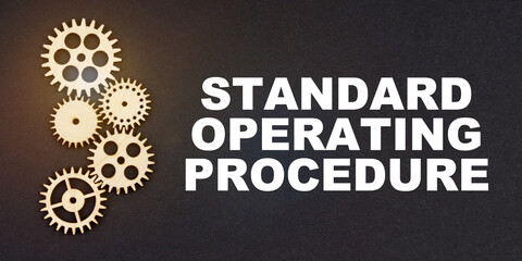 On a black background, gears and the inscription - Standard Operating Procedure