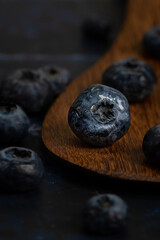 Close up of blue berry on wooden spoon